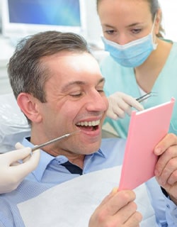 Dentures patient in Mt. Pleasant smiling at dentist