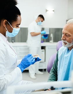 An older man consulting his dentist about dentures